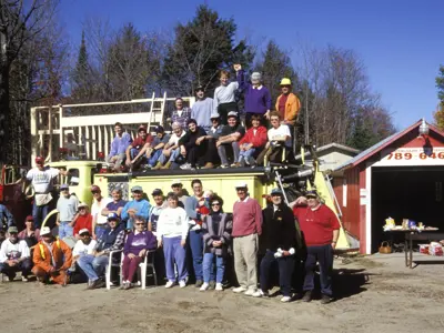 People gathered around a partially built fire station