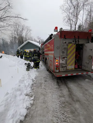 HLOB Firefighters in full gear and firetruck respond to a call.