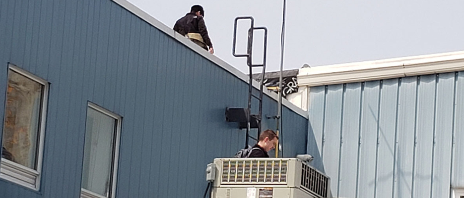 Engineering consultants reviewing and inspecting the roof at the Lake of Bays Community Centre in Baysville
