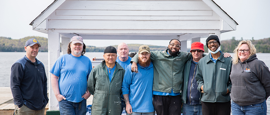 A group photo featuring offenders from the Beaver Creek Institution Community Service Volunteer Group, CO Jeff Earl, and Township of Lake of Bays employee Julie Thur, standing together as they participate in the spring cleanup efforts.