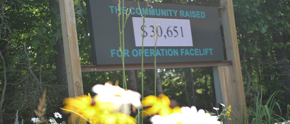 An LED sign that reads "The Community Raised $30,651 for Operation Facelift"
