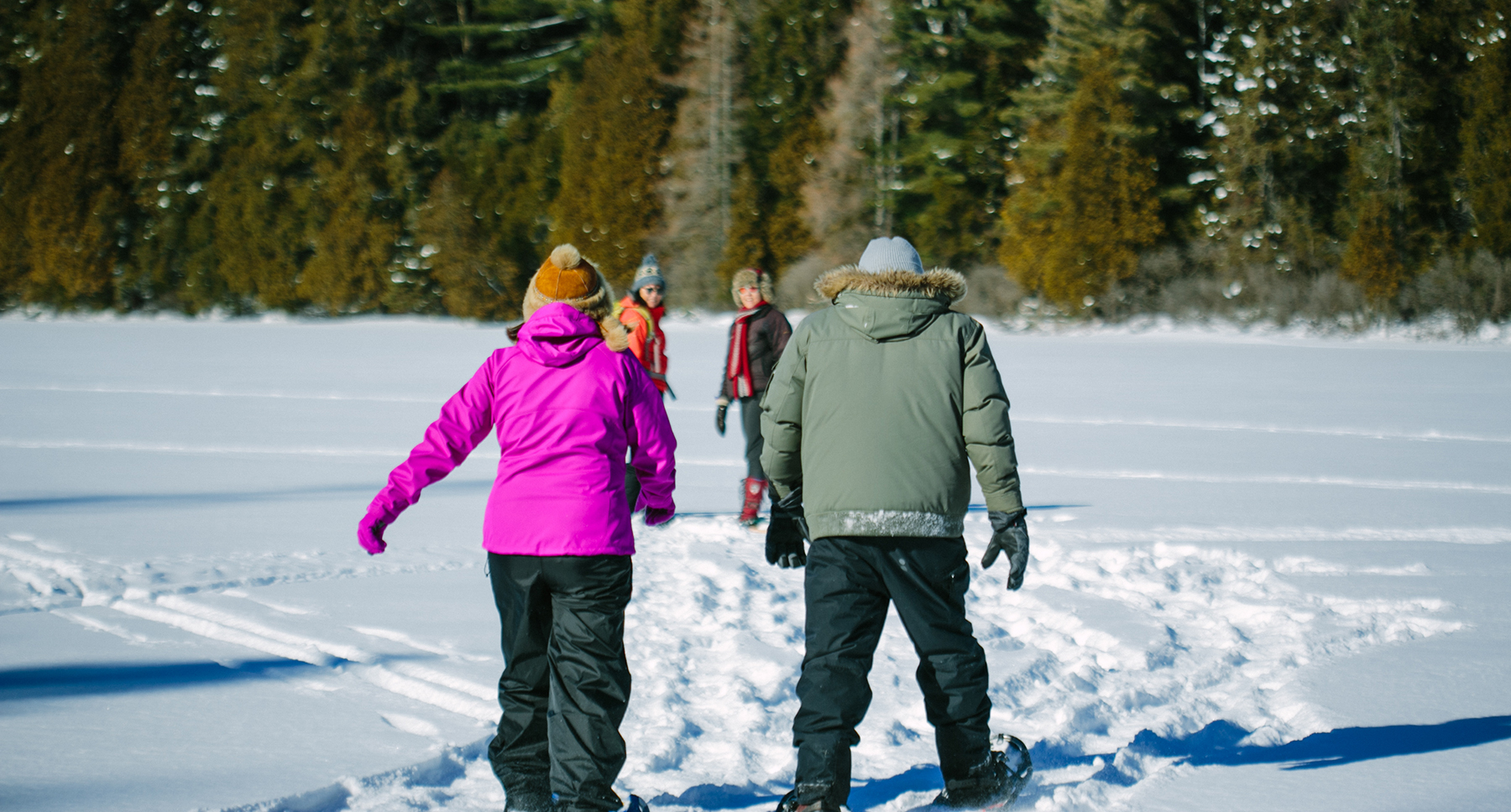 Group winter Snowshoeing on a frozen lake