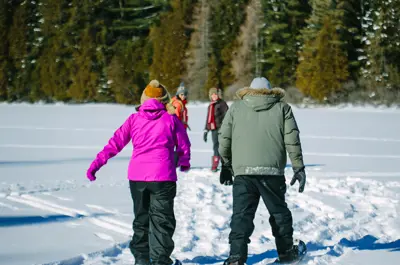 Group winter Snowshoeing on a frozen lake
