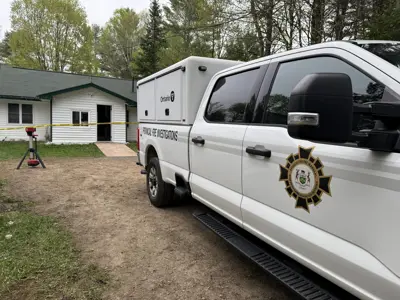 Office of the Fire Marshal vehicle outside a home following a structure fire.