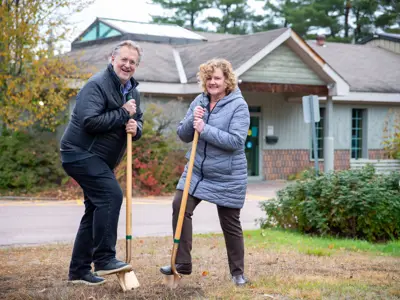 From right to left: Lake of Bays Library Board Chair Cathy Vanclieaf and Mayor Terry Glover turning sod for the groundbreaking ceremony.